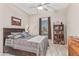 Cozy bedroom with built-in shelving and tile flooring at 42833 W Mallard Rd, Maricopa, AZ 85138