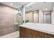 Modern bathroom with glass shower and wood vanity at 38152 N 109Th St, Scottsdale, AZ 85262