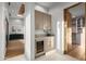 Walk-in closet with built-in shelving and wine cooler at 38152 N 109Th St, Scottsdale, AZ 85262