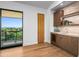 Modern wet bar with wood cabinetry and a marble countertop at 38152 N 109Th St, Scottsdale, AZ 85262