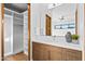 Modern bathroom with wood vanity and built-in shelving at 38152 N 109Th St, Scottsdale, AZ 85262
