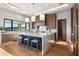 Modern kitchen with a large island, wood cabinets, and marble countertops at 38152 N 109Th St, Scottsdale, AZ 85262