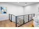 Modern staircase with metal railing and wood flooring at 38152 N 109Th St, Scottsdale, AZ 85262
