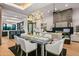 Open concept dining room with a large table, and views into the living room and kitchen at 38152 N 109Th St, Scottsdale, AZ 85262