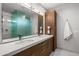 Double vanity bathroom with modern wood cabinets and quartz countertop at 38152 N 109Th St, Scottsdale, AZ 85262