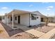 Mobile home with carport and desert landscaping at 3330 E Main St # 9, Mesa, AZ 85213