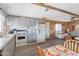 Open kitchen features gray cabinets, white appliances, and a view to the living room at 3330 E Main St # 9, Mesa, AZ 85213
