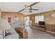 Living room with wood-paneled walls, wood flooring, and a ceiling fan at 3330 E Main St # 9, Mesa, AZ 85213