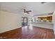 Spacious living room with wood flooring, kitchen views, and backyard access at 4010 W Campo Bello Dr, Glendale, AZ 85308