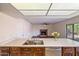 Kitchen with island, double sink, and views into living room at 4010 W Campo Bello Dr, Glendale, AZ 85308