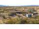 Aerial view of a desert property with main house and outbuildings at 52019 N Forepaugh Peak Rd, Wickenburg, AZ 85390