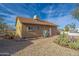 Tan house exterior with mature desert landscaping at 52019 N Forepaugh Peak Rd, Wickenburg, AZ 85390