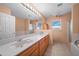 Double vanity bathroom with a large mirror and bathtub at 52019 N Forepaugh Peak Rd, Wickenburg, AZ 85390