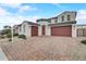 Two-story house with a red door and a brick driveway at 14219 W Artemisa Ave, Surprise, AZ 85387