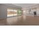 Open living area with sliding glass doors leading to the backyard and kitchen view at 23942 N 171St Dr, Surprise, AZ 85387