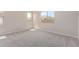 Bright bedroom with neutral carpeting and large windows at 23942 N 171St Dr, Surprise, AZ 85387
