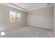 Spacious bedroom with neutral walls, carpet, and a window offering natural light at 23942 N 171St Dr, Surprise, AZ 85387