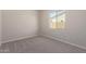 Well-lit bedroom featuring carpeted floors at 23942 N 171St Dr, Surprise, AZ 85387