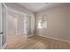 Bright home office with double doors and wood-look tile flooring at 23942 N 171St Dr, Surprise, AZ 85387
