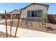 House exterior featuring a stone facade and landscaping at 23942 N 171St Dr, Surprise, AZ 85387