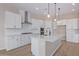 Modern kitchen with white cabinets, quartz countertops, and stainless steel appliances at 23942 N 171St Dr, Surprise, AZ 85387