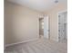 Spacious bedroom with carpet and access to another room at 23942 N 171St Dr, Surprise, AZ 85387