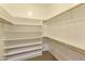 Spacious walk-in closet with built in shelving and hanging rods at 6990 E Buckhorn Trl, Scottsdale, AZ 85266