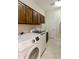 Bright laundry room with washer, dryer, and ample storage at 6990 E Buckhorn Trl, Scottsdale, AZ 85266