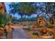 Landscaped backyard oasis with a fireplace and water feature at 6990 E Buckhorn Trl, Scottsdale, AZ 85266