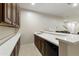 Home wet bar with white countertop and dark wood cabinets at 6990 E Buckhorn Trl, Scottsdale, AZ 85266