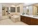 Elegant bathroom featuring a soaking tub, double vanity, and a glass block window at 6990 E Buckhorn Trl, Scottsdale, AZ 85266