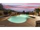 Tranquil pool and spa area with lounge chairs at dusk at 6990 E Buckhorn Trl, Scottsdale, AZ 85266