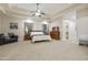 Main bedroom with carpeted floor, ceiling fan and large windows at 6990 E Buckhorn Trl, Scottsdale, AZ 85266