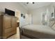 Bedroom with queen bed, ensuite bathroom, and private access to backyard at 6990 E Buckhorn Trl, Scottsdale, AZ 85266