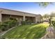 Spacious backyard with lush lawn, covered patio, and mature landscaping at 6990 E Buckhorn Trl, Scottsdale, AZ 85266