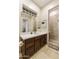 Bathroom with walk-in shower, vanity with dark wood cabinets, and white countertop at 6990 E Buckhorn Trl, Scottsdale, AZ 85266