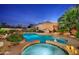 Relaxing pool and spa area with lounge chairs at night at 6990 E Buckhorn Trl, Scottsdale, AZ 85266