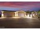 Elegant home exterior with a two-car garage at dusk at 6990 E Buckhorn Trl, Scottsdale, AZ 85266