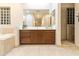 Bathroom with a double vanity and a large mirror reflecting the room at 6990 E Buckhorn Trl, Scottsdale, AZ 85266