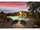 Backyard oasis with a sparkling pool and spa at sunset at 6990 E Buckhorn Trl, Scottsdale, AZ 85266