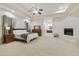 Spacious main bedroom with carpeted floor, fireplace, and ensuite bathroom at 6990 E Buckhorn Trl, Scottsdale, AZ 85266