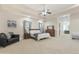 Large main bedroom with carpeted floor, ceiling fan, and ensuite bathroom at 6990 E Buckhorn Trl, Scottsdale, AZ 85266