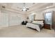 Main bedroom with carpeted floor, ceiling fan and large windows at 6990 E Buckhorn Trl, Scottsdale, AZ 85266