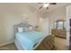 Cozy bedroom with ceiling fan, dresser, and teal bedding at 6990 E Buckhorn Trl, Scottsdale, AZ 85266