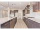 Modern kitchen with island, stainless steel appliances, and white quartz countertops at 16408 W Creedance Blvd, Surprise, AZ 85387