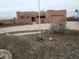 Front view of a stucco home with a flagpole and basketball hoop at 25645 W Blue Sky Dr, Wittmann, AZ 85361
