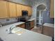 Kitchen with stainless steel appliances and wood cabinets at 25645 W Blue Sky Dr, Wittmann, AZ 85361