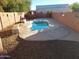 Relaxing kidney-shaped pool in the backyard at 25645 W Blue Sky Dr, Wittmann, AZ 85361