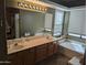 Double vanity bathroom with soaking tub and large window at 25645 W Blue Sky Dr, Wittmann, AZ 85361