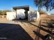 Covered RV storage with adjacent containers at 25645 W Blue Sky Dr, Wittmann, AZ 85361